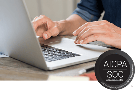 Close-up of a person’s hands typing on a laptop showing 