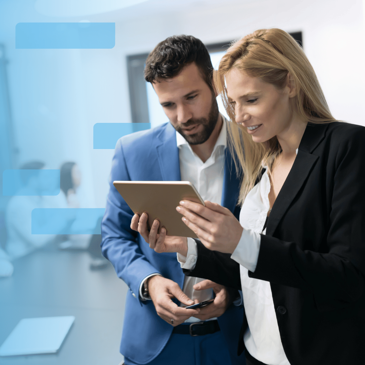 Two attorneys looking at a tablet in a boardroom