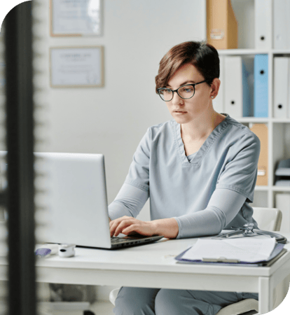 doctor at desk with computer